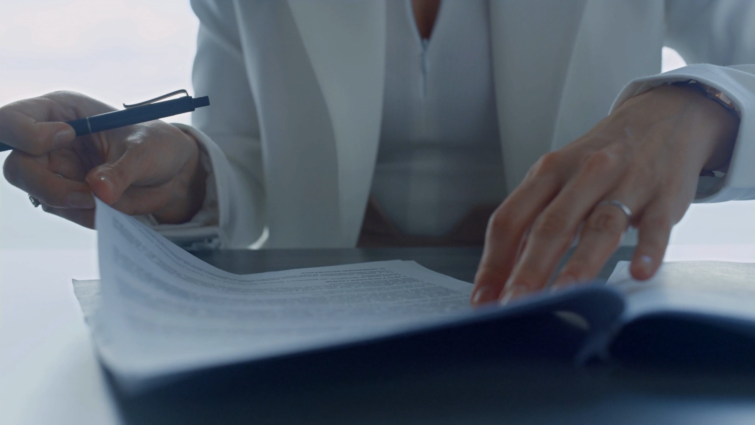 01 businesswoman hands checking contract closeup lawyer reading legal documents in sui SBV 347069833 4K 00.00.15.481 scaled