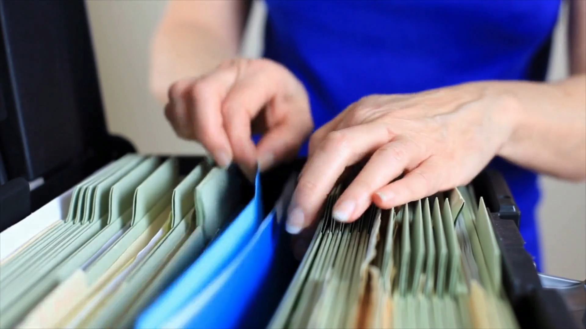 An employee filing papers and reviewing information