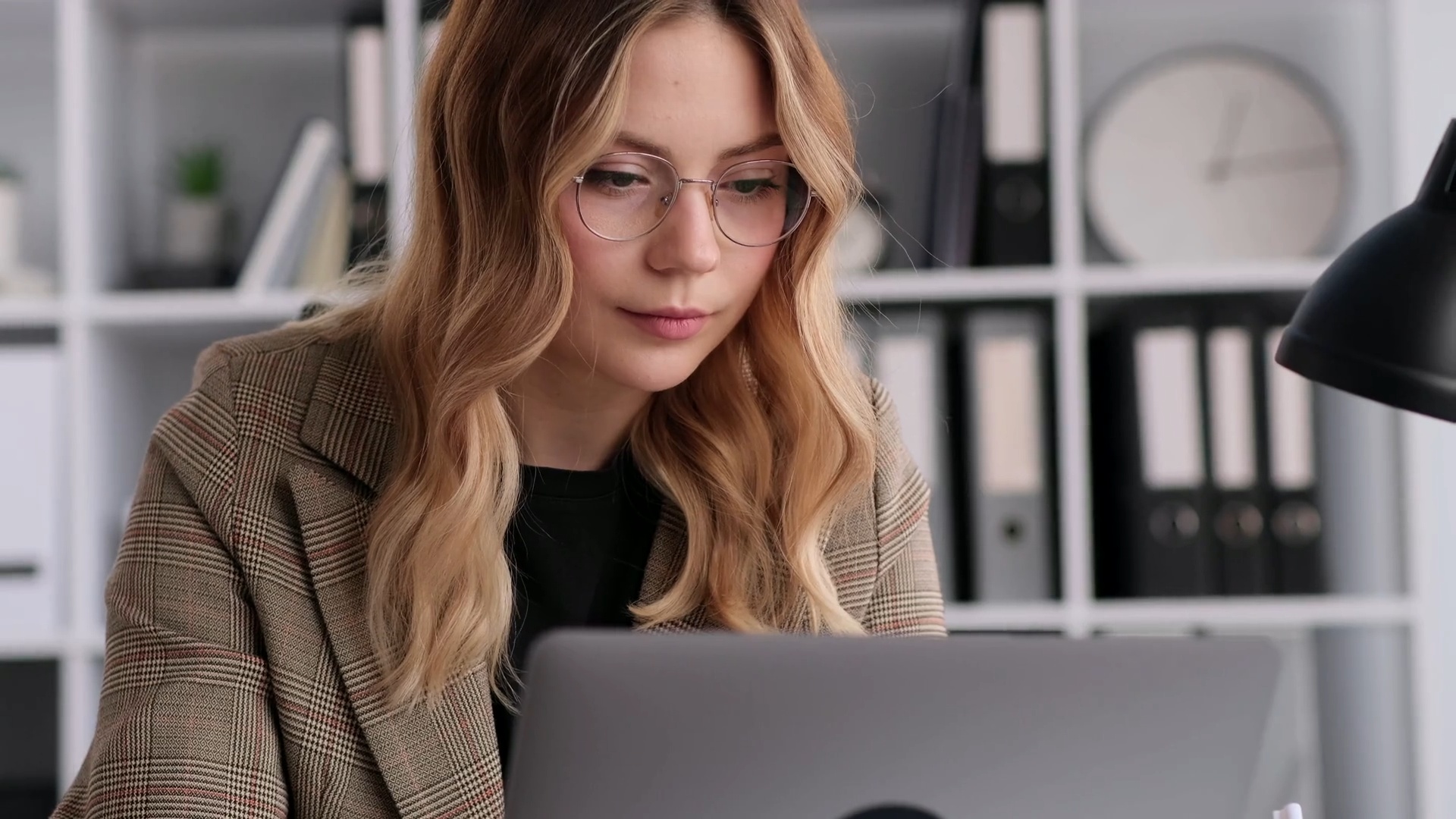 Manager typing an email to an employee