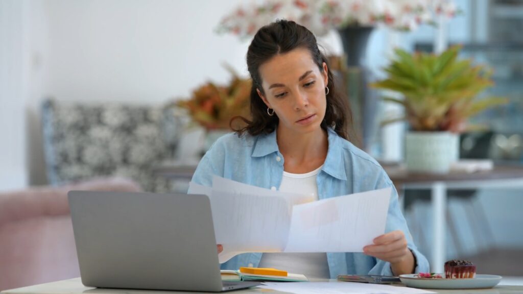 Employee reviewing job postings and updating their resume after termination.